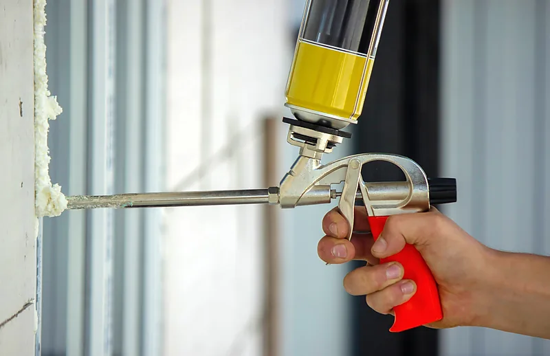 Air sealing a door frame gap with foam